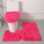 Plush bathroom rug set with toilet lid cover and mat in a cozy bathroom