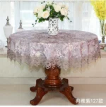 Elegant lace tablecloth with rose gold embroidery on a dining table