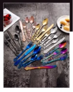 Gold flatware set with spoon, fork, and steak knife on a white tablecloth
