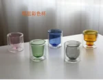 Clear double wall insulated glass mug with espresso coffee on wooden table