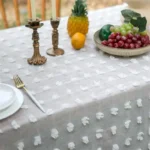 Retro polka dot tablecloth with fringe on a wooden table