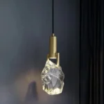 Modern crystal pendant lamp illuminating a dining room with elegant light refraction