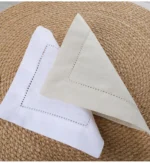 White linen cloth napkins hemstitched cocktail napkins set of 100 on wooden table