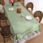 French country tablecloth with retro plaid pattern and lotus leaf edge on a dining table