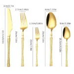 Goldoma stainless steel cutlery set with hammer pattern handles on a wooden table