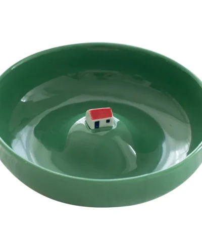 Set of abstract ceramic plates with colorful three-dimensional designs on a dining table