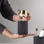 Side view of a white ceramic foam soap dispenser with a textured surface and silver pump.