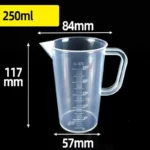 Transparent plastic lab beaker with measurement scale on kitchen counter