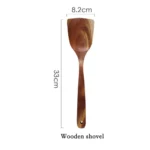 Wooden cooking utensils set with spatula, soup ladle, and rice scoop on a kitchen counter