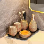 Close-up of the ceramic toothbrush holder with a floral motif, soft shadows.