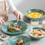 Vancasso KARST green stoneware dinner set with embossed plates and bowls on a rustic wooden table