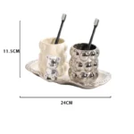 Electroplated ceramic mug set in bathroom cabinet, with toothbrushes and toothpaste inside.
