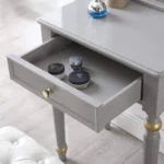 Modern white dressing table with mirror and stool in a bedroom setting