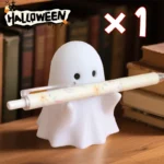 The white ceramic pencil holder with a smiling ghost face, from a low angle.