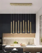 Brushed steel pendant light with tapered shade in a modern study.
