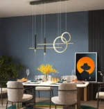 Gold and black pendant light with a drum shade over a dining table.