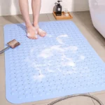 Non slip bath mat with suction cups in a white bathroom