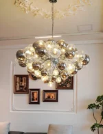 Smoky gray chandelier with glass bubbles hanging over a modern dining table