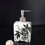 Lotion bottle and soap dish paired together on a wooden bathroom cabinet.