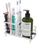 Luxspire stainless steel toothbrush holder on bathroom countertop, sleek silver finish with drainage holes visible.