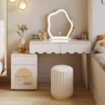 Modern makeup vanity desk with mirror and stool in a bedroom setting, showcasing ample storage and elegant design