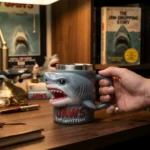 Jaws 50th Anniversary 3D shark mug on a wooden table with coffee