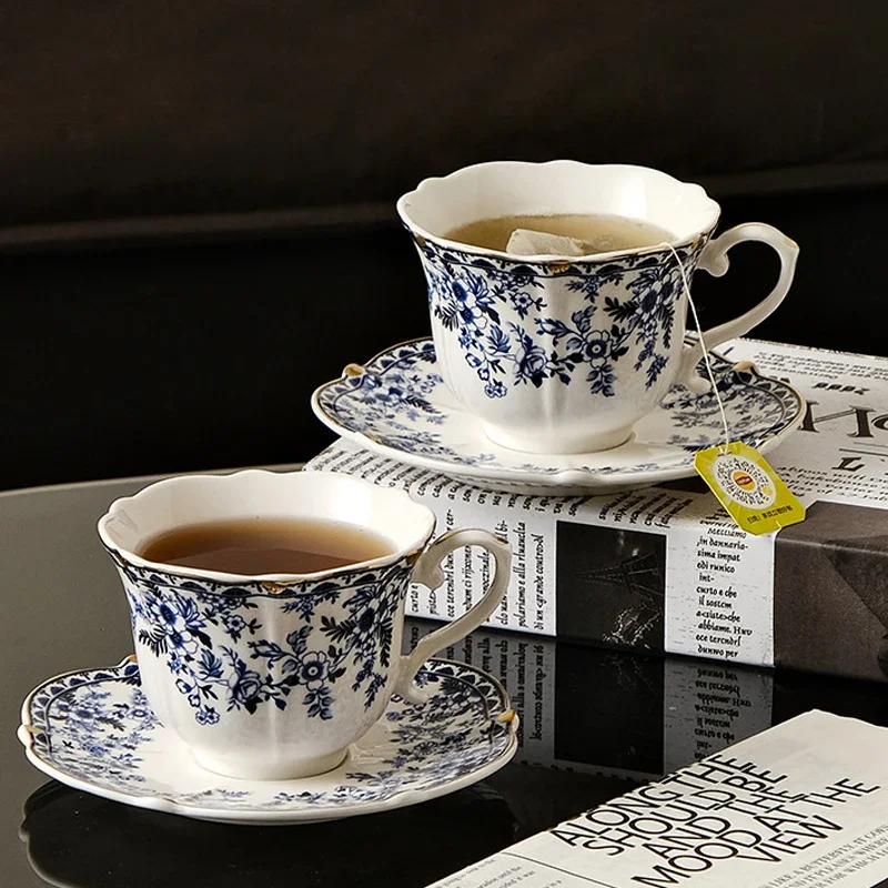 Blue white porcelain coffee mug with saucer on rustic wooden table