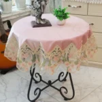 Elegant lace tablecloth with rose gold embroidery on a dining table