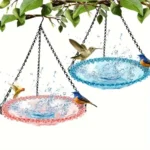 Close-up of the hanging bird bath showing the textured blue ceramic bowl and metal hanger.