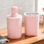 Complete pink bathroom accessory set arranged on a white marble tray.
