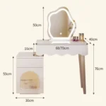 Modern makeup vanity desk with mirror and stool in a bedroom setting, showcasing ample storage and elegant design