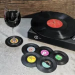 Set of vinyl record coasters on a wooden table