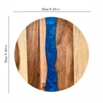Round acacia cutting board with resin inlay on kitchen counter