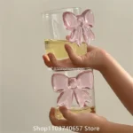 Elegant pink bow glass cup with heat-resistant borosilicate glass, perfect for champagne and cold drinks