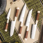 Professional chef knife set with wood handles on cutting board