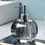 Shampoo bottle in clear glass, label-free, front view.