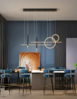 Gold metal pendant light with a matte finish hanging low over a table.