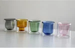 Clear double wall insulated glass mug with espresso coffee on wooden table