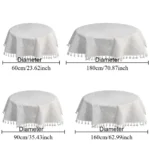 Round linen tablecloth with tassels on a dining table