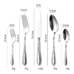 Elegant stainless steel flatware set with mirror finish arranged on a wooden table