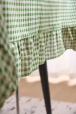 French country tablecloth with retro plaid pattern and lotus leaf edge on a dining table