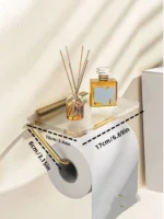 Acrylic tray of the toilet paper holder holding small bathroom accessories like a phone or comb.