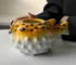 Creative pufferfish tiki mug for cocktails with vibrant hand-painted details on a wooden table