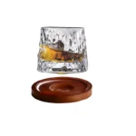 Rotating whiskey glass with wooden base on a bar table