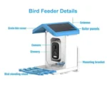 Solar panel on top of the bird feeder camera, angled towards the sun, with a wooden deck and plants in the background.