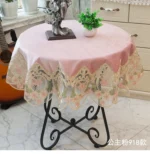 Elegant lace tablecloth with rose gold embroidery on a dining table