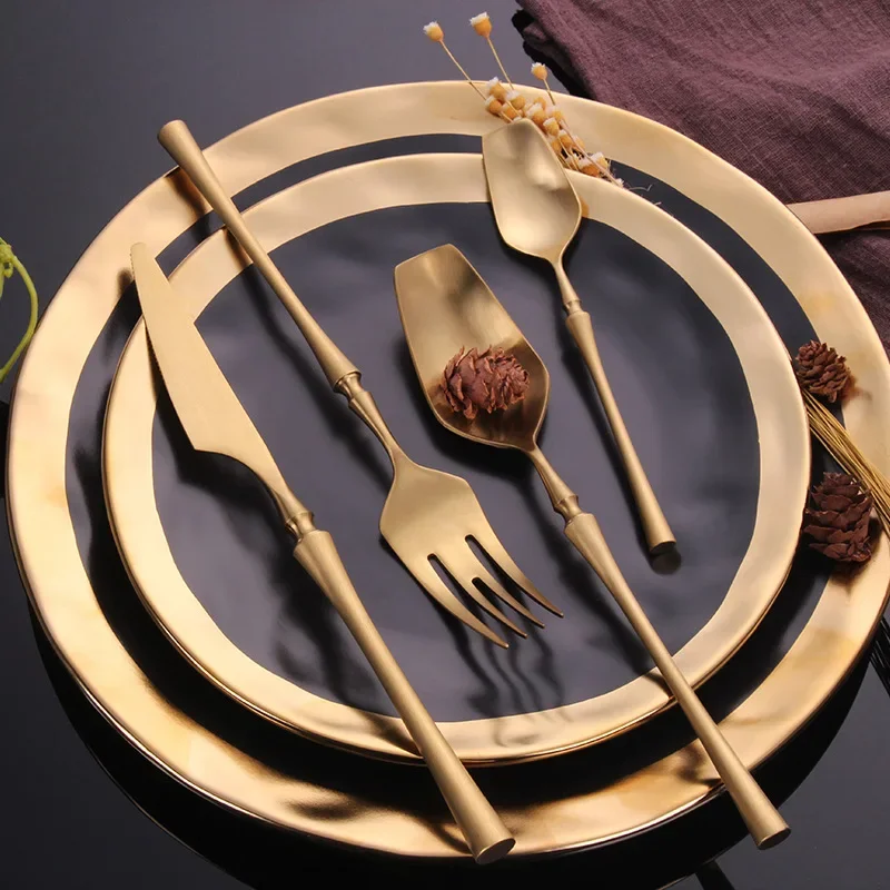 Matte black gold flatware set arranged on a table, showcasing elegant cutlery