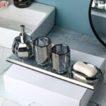 Toothbrush holder cup holding electric toothbrush.