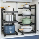Stainless steel kitchen cabinet organizer with multi-layer shelves holding pots and pans under sink