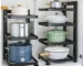 Stainless steel kitchen cabinet organizer with multi-layer shelves holding pots and pans under sink